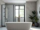 Stylish bathroom featuring black frame shower doors, modern decor, and natural light setting.