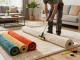 Home carpet fitting services showcasing a professional carpet installer working in a bright living room, ensuring perfect carpet placement.