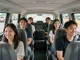 5,6,7,8 seater taxi with passengers smiling during airport transfer, showcasing comfort and convenience.
