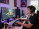 Player engaging in an exciting session to tải hitclub on a modern gaming setup with vibrant LED lighting.