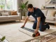 Expert carpet fitter installing luxurious carpet in a modern living room, showcasing carpet fitting services West London.