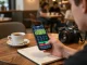 Placing a bet on SHBET .COM app during a casual cafe visit to enhance gaming experience.