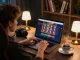 Engaged player exploring lucky88 online casino interface with vibrant slots in cozy gaming setup.