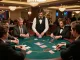 C168 poker table action with players placing bets and dealer distributing cards in a luxurious casino setting