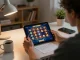 Engage in the latest slot terbaru gameplay while strategizing at home with tablet and notes.