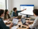 Collaborators exploring the Sky Glass IPTV Reseller Panel in a bright modern workspace, discussing strategies for IPTV subscriptions.