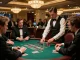 Players strategizing at a blackjack table in a casino, showcasing 7m stakes with intense focus.