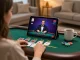Kuwin player engaging in live dealer blackjack on a tablet in a cozy home setting.