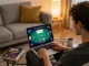 Player engaging in online poker at fly88 com from their cozy living room with strategic notes around.