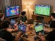Friends enjoying hit club gaming with vibrant genres and friendly competition in a cozy setting.