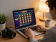 Player enjoying gg88 slot game on laptop, warm home atmosphere showing strategic online gaming.