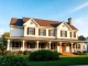Showcasing a beautiful colonial home addition with charming architecture and inviting landscaping.