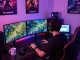 Engaging gaming setup showcasing tải sunwin on multiple screens in a vibrant space.
