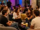 Engaging adults in a vibrant social setting discussing sexchat, colorful ambiance, and conversation.