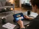 Playing SC88 OKVIP mobile games on a tablet at a modern home desk