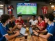 Friends enjoying the excitement of NOWGOAL live soccer scores in a vibrant sports bar