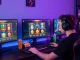 Player enjoying non UKGC casinos while engaging with vibrant gaming interface and snacks in an immersive setup.